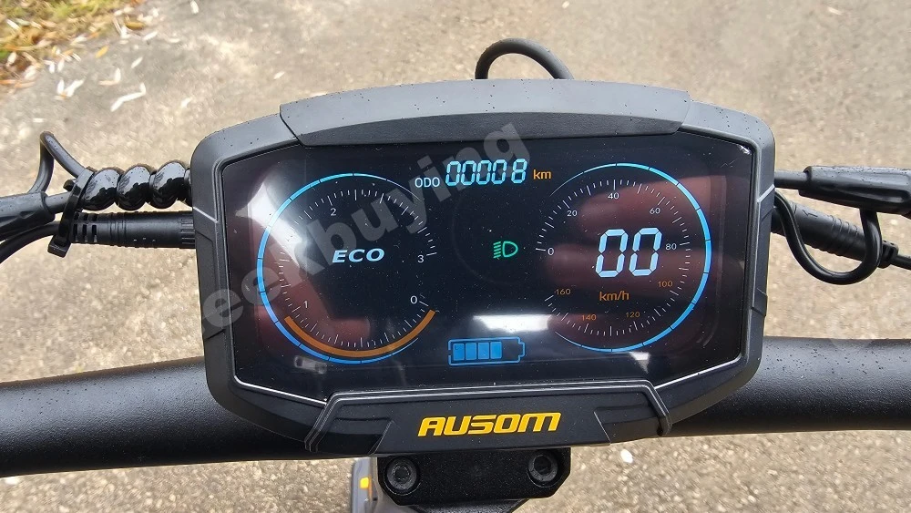 Rider's point-of-view (POV) showing the Ausom DT2 Pro handlebar display and a hand using an NFC card to unlock the scooter.
