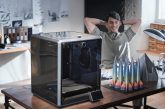 A compact silent 3D printer integrated into a clean, modern European home office workspace