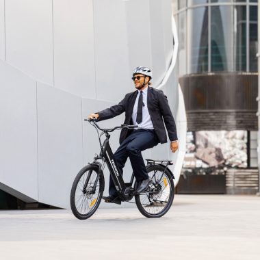 E-bike rider commuting in a European city as part of a realistic fitness routine